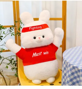 Cute white rabbit plush toy doll detail showing cute face, red headband and red shirt.