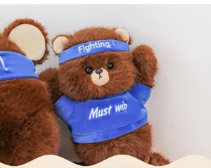 Cute brown bear plush toy doll with blue headband and shirt, soft stuffed animal gift.