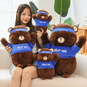 Cute brown teddy bear plush doll toy with fighting headband and blue shirt gift.