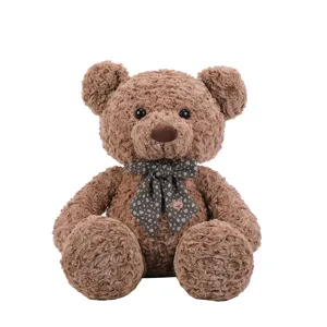 Grand ours en peluche marron avec nœud papillon, douce poupée pour cadeau idéal.