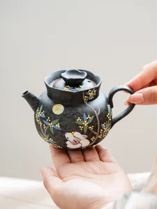 Detailed view of handcrafted ceramic teapot featuring delicate rabbit and osmanthus flower.