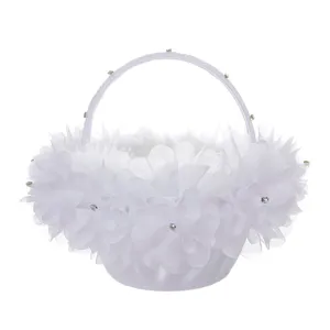 White wedding flower girl basket with lace, rhinestones and fabric flowers for ceremony.