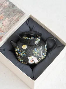 Black ceramic teapot featuring traditional white rabbit and osmanthus motif with gift box.