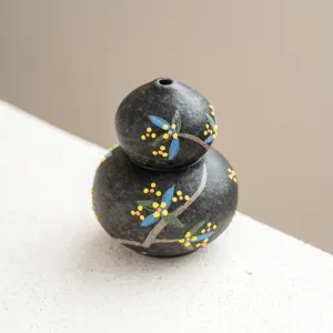 Portainciensos de calabaza de cerámica artesanal con textura negra y diseño floral.