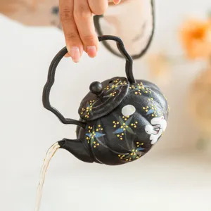 Black ceramic teapot with cute rabbit and flower pattern, ideal for solo gongfu tea time.