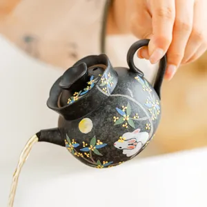 Ceramic teapot with rabbit and osmanthus pattern, black teapot for single person tea brewing main image.