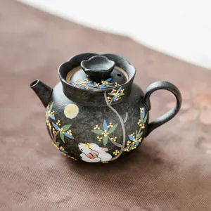 Black ceramic teapot with hand-painted rabbit motif, elegant design for home tea lovers.