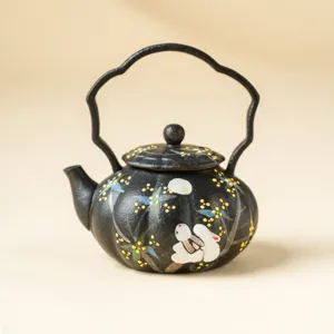 Hand-painted black ceramic teapot featuring unique arch handle and cute rabbit moon motif design.
