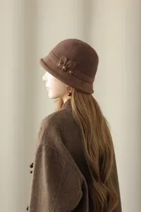 Elegant brown wool bucket hat with delicate floral rhinestone side detail for vintage winter style.