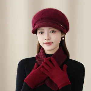 Close-up of wine red wool knit beret, matching scarf and gloves set showing fine texture details.