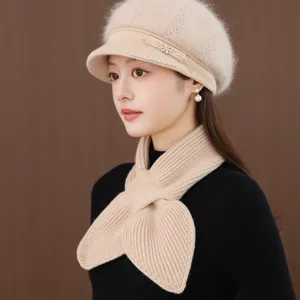 Detail shot of women's warm winter wool knitted beret hat and scarf set in beige.