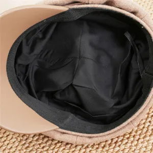 Detail view of the inner lining and brim of a stylish brown newsboy octagonal hat.