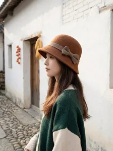 Side view detail of the elegant brown wool felt bucket hat featuring a chic side bow.