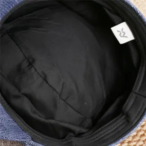 Detailed view of the stylish denim beret lining and inner tag, showing quality craftsmanship.