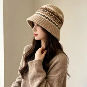 Detailed view of women knitted bucket hat, autumn warm roll-brim design with stylish pattern.