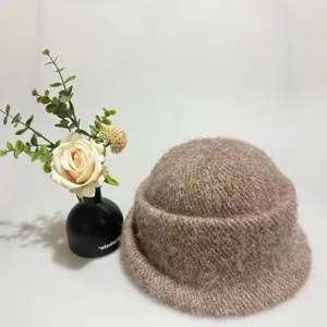 Detailed shot of the soft faux rabbit hair knitted basin hat, cozy winter rolled brim.