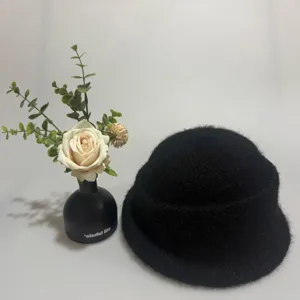 Detail view of black furry knit bucket hat, soft warm winter roll brim vintage style.