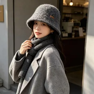 Detail view of a stylish knitted bucket hat for women, featuring a rolled edge and warm winter design.