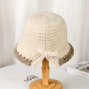 Chic autumn winter knitted bucket hat with brown trim and bow, elegant warm fashion hat.