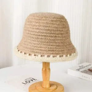 Detailed view of women knit bucket hat, casual warm winter retro hat in beige brown style.