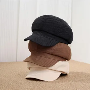 Corduroy newsboy octagonal hat detail showing stacked black brown beige retro style fabric.