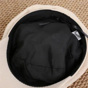 Detailed view of the inside of a cute Japanese style cat ear beret hat with black lining.