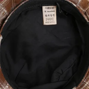 Brown plaid beret hat interior detail showing brand label and quality lining craftsmanship.