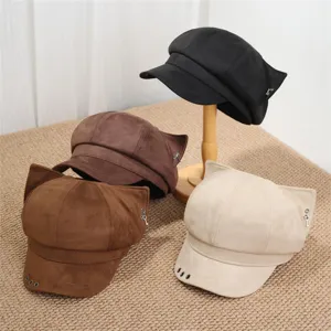 Detail view of cute cat ear newsboy caps in multiple colors featuring metal ring accents.