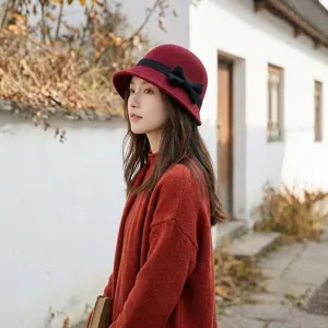 Vintage Hepburn style wool bucket hat with black bow, elegant autumn winter fashion accessory.