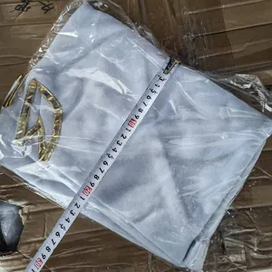 Detailed view of a white non-woven Christmas tree skirt with gold embroidery design.