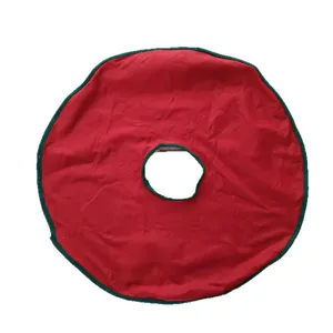 Festive red Christmas tree skirt with green trim, round holiday tree decoration mat.