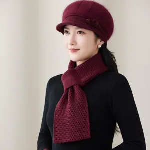 Detail shot of women winter warm knitted beret hat and scarf set in solid burgundy color.
