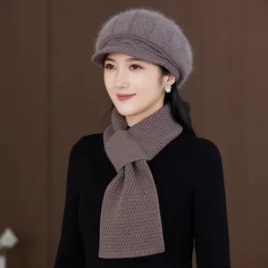 Detailed view of women's warm knitted beret and scarf set in grey brown winter style.