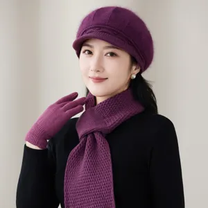 Detail shot of purple knitted beret scarf and gloves set for autumn winter warmth.