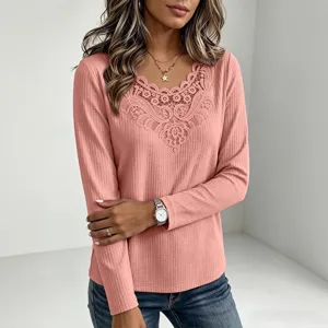 Detailed shot of a pink waffle knit long sleeve t-shirt featuring elegant lace v-neck trim.