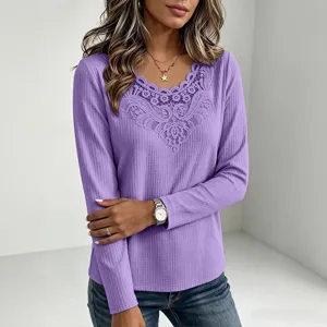 Detail view of a purple waffle-knit long-sleeve top featuring elegant V-neck lace trim.