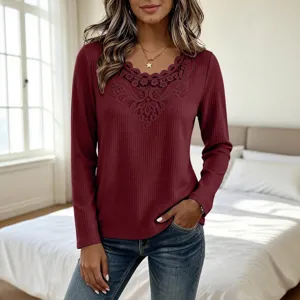 Detail view of women's waffle knit long sleeve top featuring elegant lace V-neck trim.