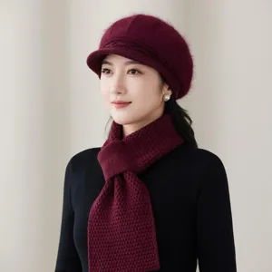 Close-up detail of the warm plush knit beret and matching scarf in a rich burgundy color.