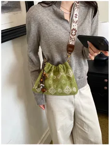 Retro vintage green embroidered crossbody bag detail, chic ethnic wide strap accessory.