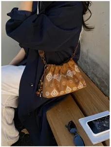 Retro brown suede shoulder bag for women with vintage embroidered patterns and chic beaded charms.