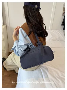 Minimalist solid color Boston shoulder bag, retro commute design with knot strap detail.