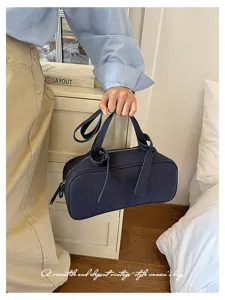 Detail shot of the vintage blue boston handbag showcasing its elegant handle and sleek silhouette.