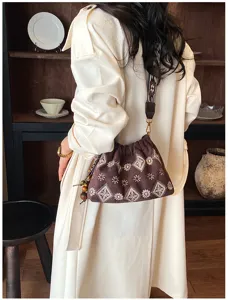 Retro embroidered shoulder bucket bag for women with delicate patterns and wide strap.
