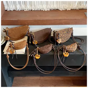 Retro suede crescent dumpling bags for women, stylish crossbody and shoulder bags with charms.