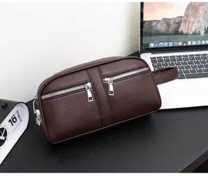 Detailed view of men's dark brown leather clutch bag with dual zippers and side handle.