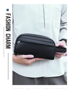 Detail shot of the black leather men's clutch bag, showing the premium textured material.