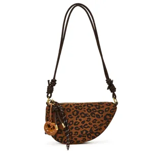 Leopard print saddle shoulder bag for women, stylish retro crossbody purse with chic knot charms.
