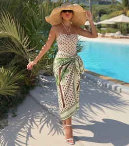Chic european beachwear set featuring strapless swimsuit and palm tree sarong for women.