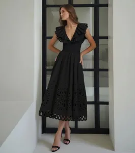 Elegant black cutout midi dress detail view, featuring ruffle V-neck and intricate hem embroidery.