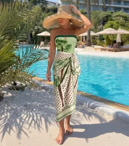 Stunning strapless palm tree print one-piece swimsuit and sarong resort set for beach summer vacation.